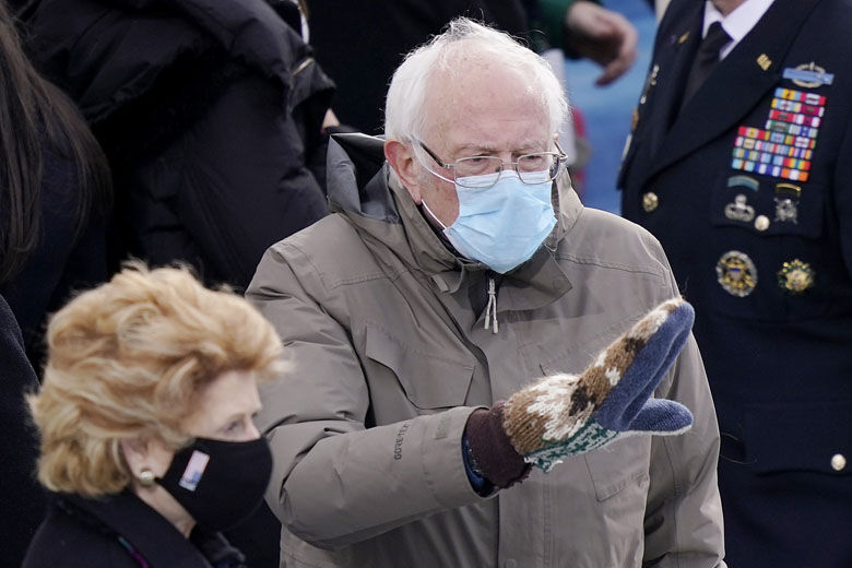 Sanders interacts with people at the inauguration with his fleece gloves.