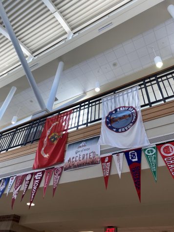 Flags from all of the colleges the class of 2022 was accepted into hang in the commons area.