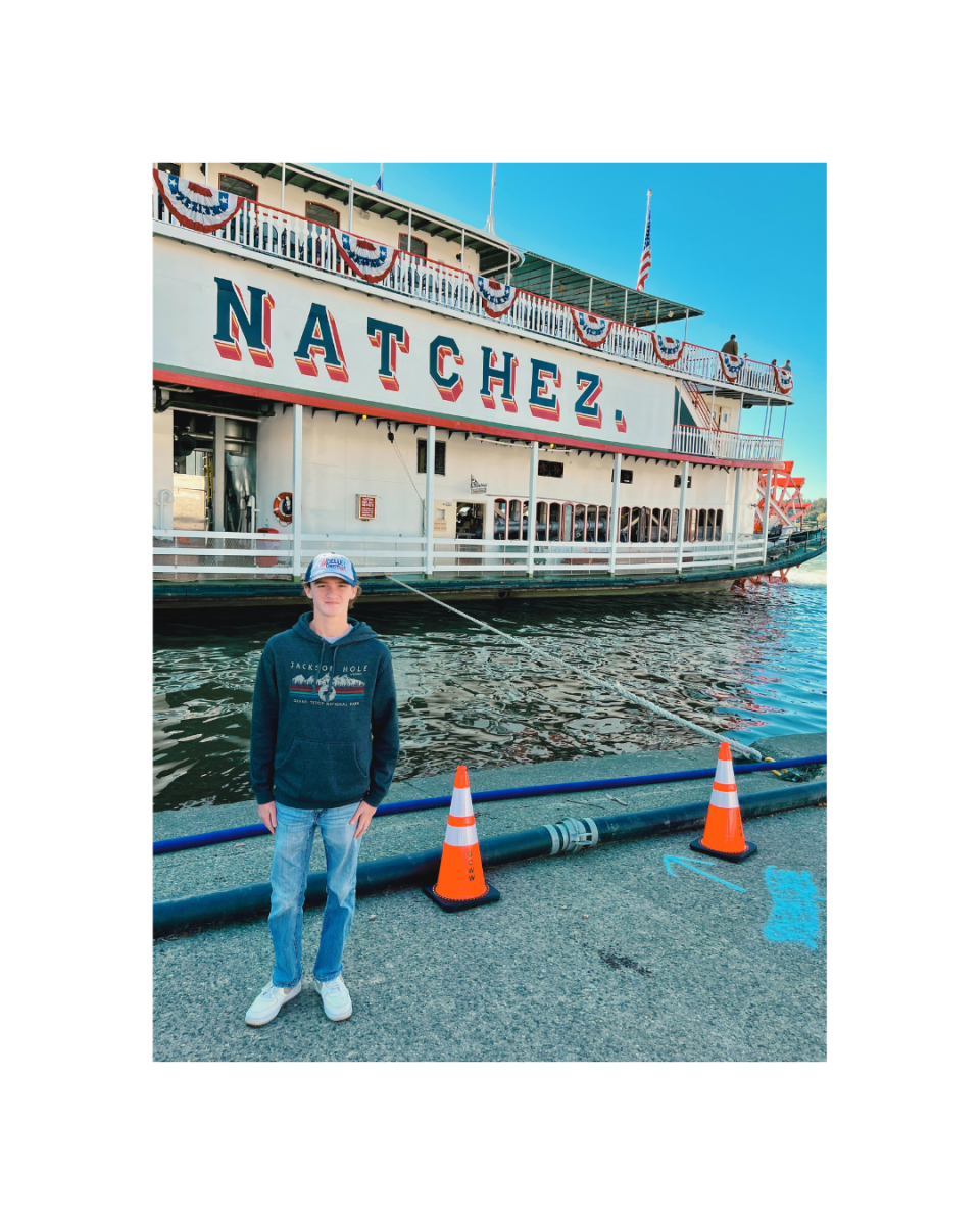 Sophomore Ellis Smith standing in front of Steamer Natchez at America's River Roots Festival in early October. 